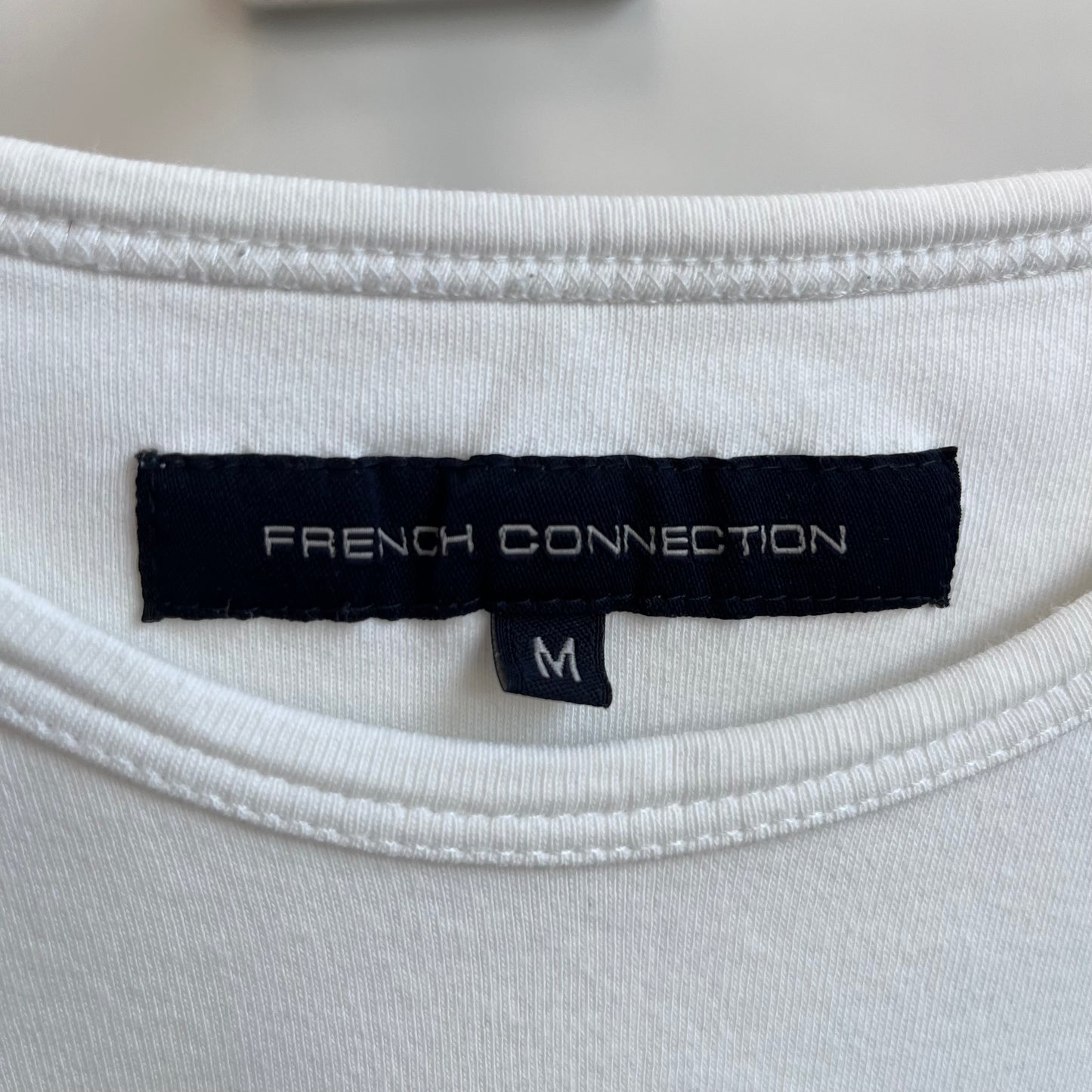 FCUK positions tee